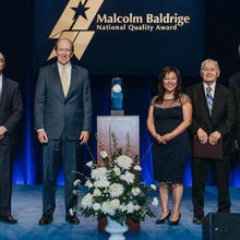 5 people standing on a stage