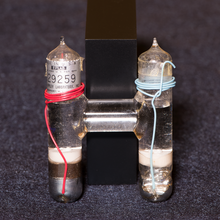 inside of a Weston cell. Two cylinders, one with red wire, one with blue wire
