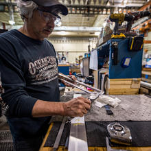 Machinist Mark Hutton uses hand calipers