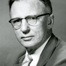photograph portrait of a middle-aged, bespectacled man