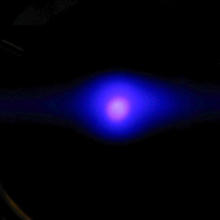 black background with a bluish-purple circle of light in the middle