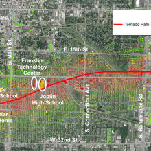 Aerial image of Joplin, Mo, with lines of the tornado path and levels of damage.