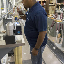 A scientist looking in a microscope