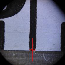 Hash marks on a tape measure, as viewed under a microscope.