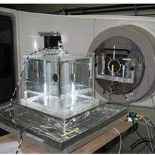Graphite transfer ionization chamber in a water phantom and monitor chambers attached to accelerator head for dose normalization.