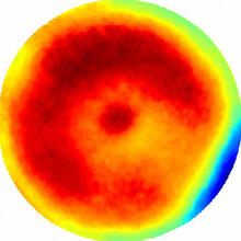 circle of colors. there is red and orange in the middle with a thin ring of yellow on the edges. One side also has a half ring of green and blue.