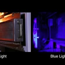 In this photo, we see a split-screen image of a laboratory fire. The left side shows the fire obscuring the view of an object behind it while the right side shows the same object with the clarity dramatically enhanced using ordinary blue light.