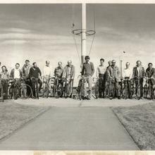 A group of 16 people with their bikes