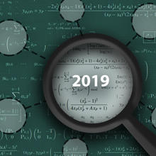 A magnifying glass with "2019" in its lens hovers over a green field of math equations, with circles suggesting the magnifying glass has located some of the information.