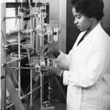 A woman working at a lab bench