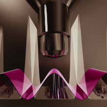 A microscope lens aims downward at a magenta-colored wave.