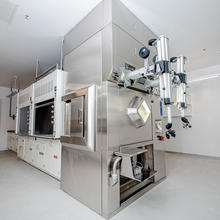 A large metal machine features two cylindrical controllers on one end.