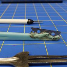 three weapons on a blue checked background