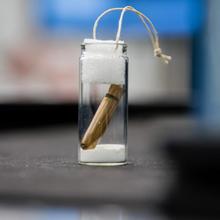 a bullet inside a small glass vial