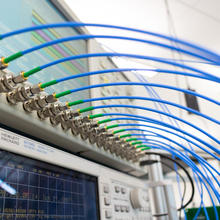 An image of radio frequency indoor localization and mapping hardware with a generator and antenna lines.