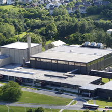 View from above shows NIST's Center for Neutron Research building with green lawns and trees.