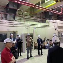 Individuals in hard hats in a lab