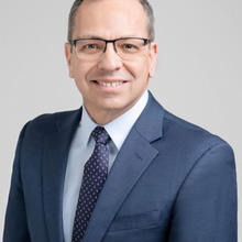 headshot of a man in a suit