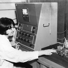 A woman in a lab coat working with electricity cells