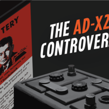 Red box of AD-X2 on the left. Words: The AD-X2 Controversy. Partial view of a car battery.