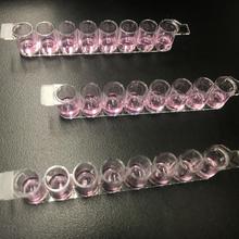 Rows of tiny vials hold similar amounts of what looks like purple liquid. 