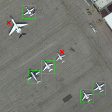 Multiple airplanes on the tarmac. Some are surrounded by a green box and others by a red X.