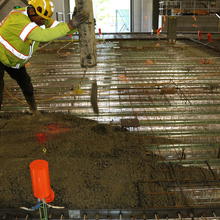 Man in a hardhat installing a floor