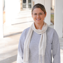 Justyna Zwolak poses for a casual photo outdoors on the NIST campus.