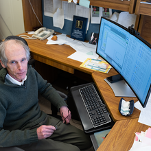 Alexander Kramida looks up as he sits at his desk in front of a computer screen full of data.
