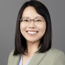 Professional headshot of Ran Tao, a woman with medium length, dark hair and glasses, smiling.