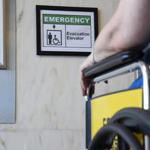 Image of a wheelchair in front of an elevator