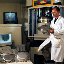 NIST researcher with metal stamping equipment