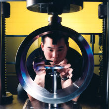 Man looks through center of proving ring