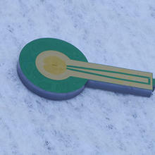 NIST chip containing a single-photon detector made of superconducting nanowires. Four chips like this were used in the experiment that entangled three photons.