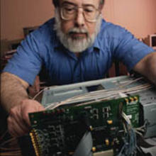 Alan Mink works on a programmable printed circuit board used to process data for the new NIST quantum key distribution system. 