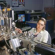  postdoctoral researcher Lucile Teague inserts a sample into a scanning tunneling microscope to study the electrical behavior of organic molecules on a gold surface.