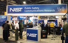 PSCR booth at CES with technology and bomb suit displayed and attendees interacting with PSCR staff