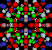 red, blue, grey, brown and blue spheres representing aluminum, lithium and copper atoms organized in a geometric pattern