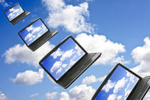 computers with clouds on screens floating in clouds