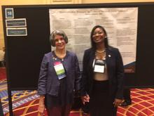 Jan Garfield and Tammy Jameson standing side by side at symposium