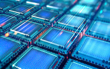 artist's concept of the inside of a quantum computer. A grid of blue computer chips with beams of light moving between them. 