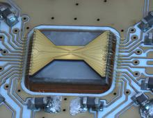 Ion trap with integrated superconducting photon detector