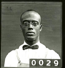 young-adult Black man wearing glasses and a bowtie
