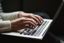 person typing on a laptop