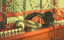 Photo of an old fashioned manual telephone exchange switchboard.