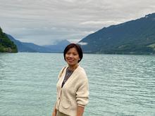 Woman in white sweater by a lake