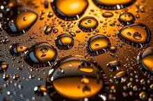 Photograph of droplets on a surface illuminated with golden light