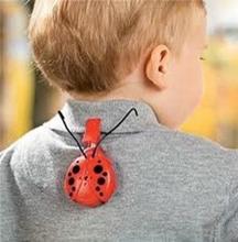 Tracking device on the collar of a child's grey polo.
