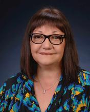 woman with brown hair wearing glasses