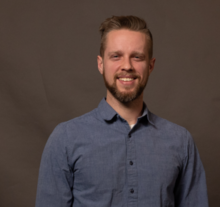 smiling man wearing blue shirt